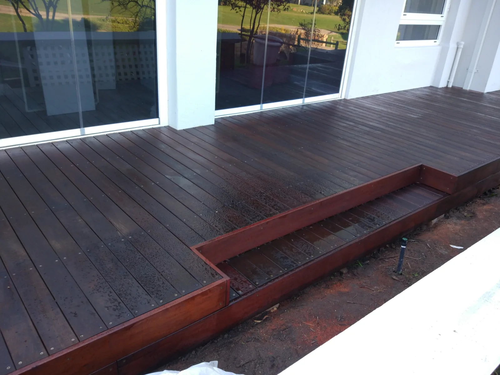 Massaranduba hardwood patio decking with integrated steps outside a residential home